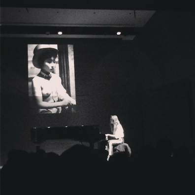 @rishadmistri's striking photograph of Diane Birch performing live at the Rubin Museum. A projection of a photograph from our exhibition "Witness at a Crossroads" can be seen in the background.