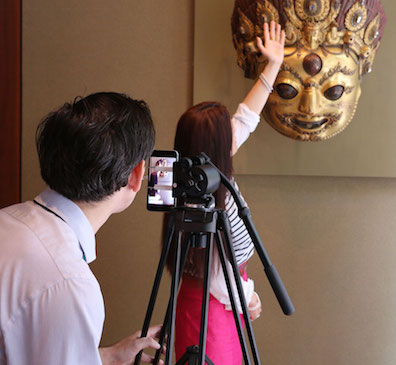 Tashi describes the role a mask like this, which dispenses beer to devotees, would play in Nepalese festivals.